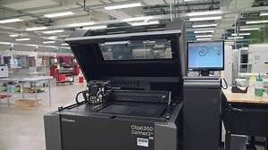 PolyJet is a 3D printing technology capable of building parts with multiple colors and variable hardnesses. It's most often used to prototype overmolded and elastomeric part designs. | Protolabs